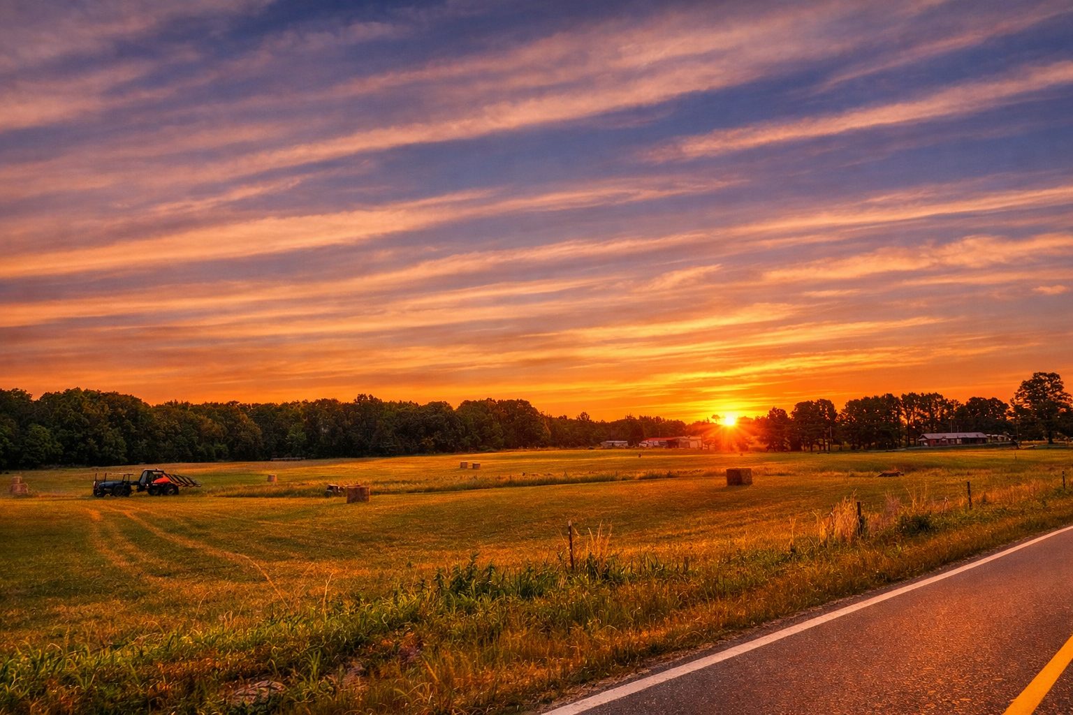 Sunset over rural farmland in West Tennessee near Beech Bluff with open acreage and country road.
