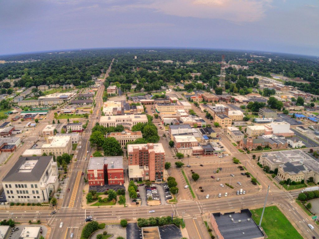 Aerial view of downtown Jackson Tennessee showing businesses, streets, and local amenities.