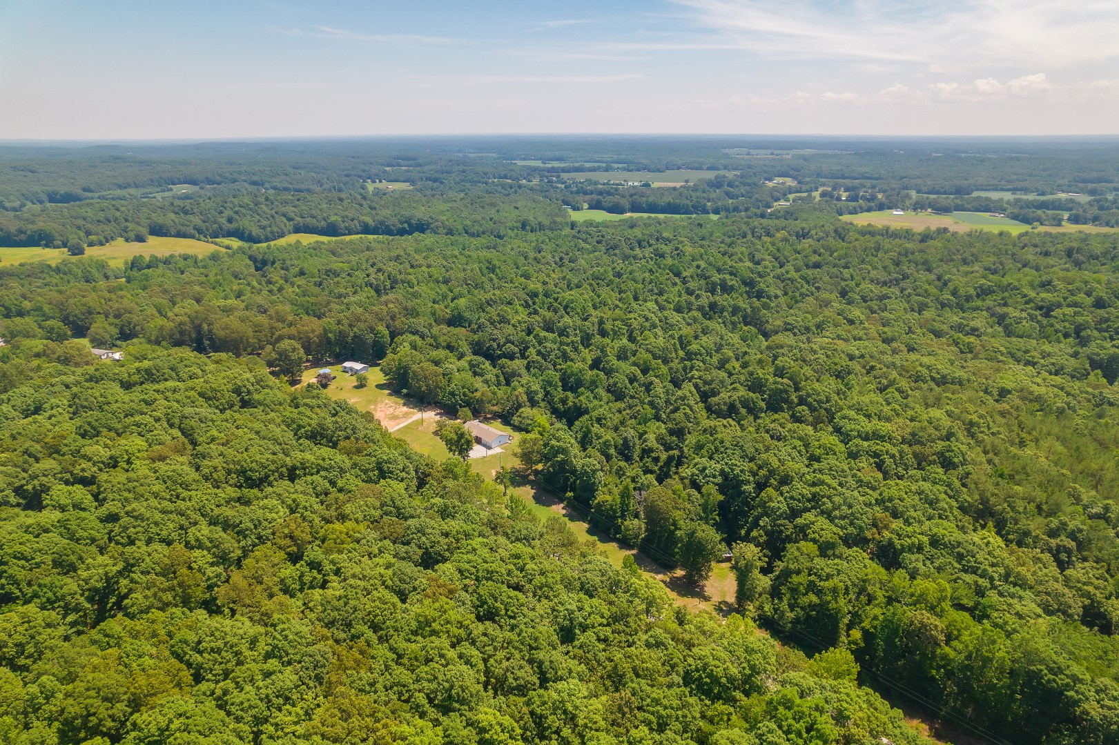 Drone view of rural homes and wooded acreage in West Tennessee near Jackson TN.